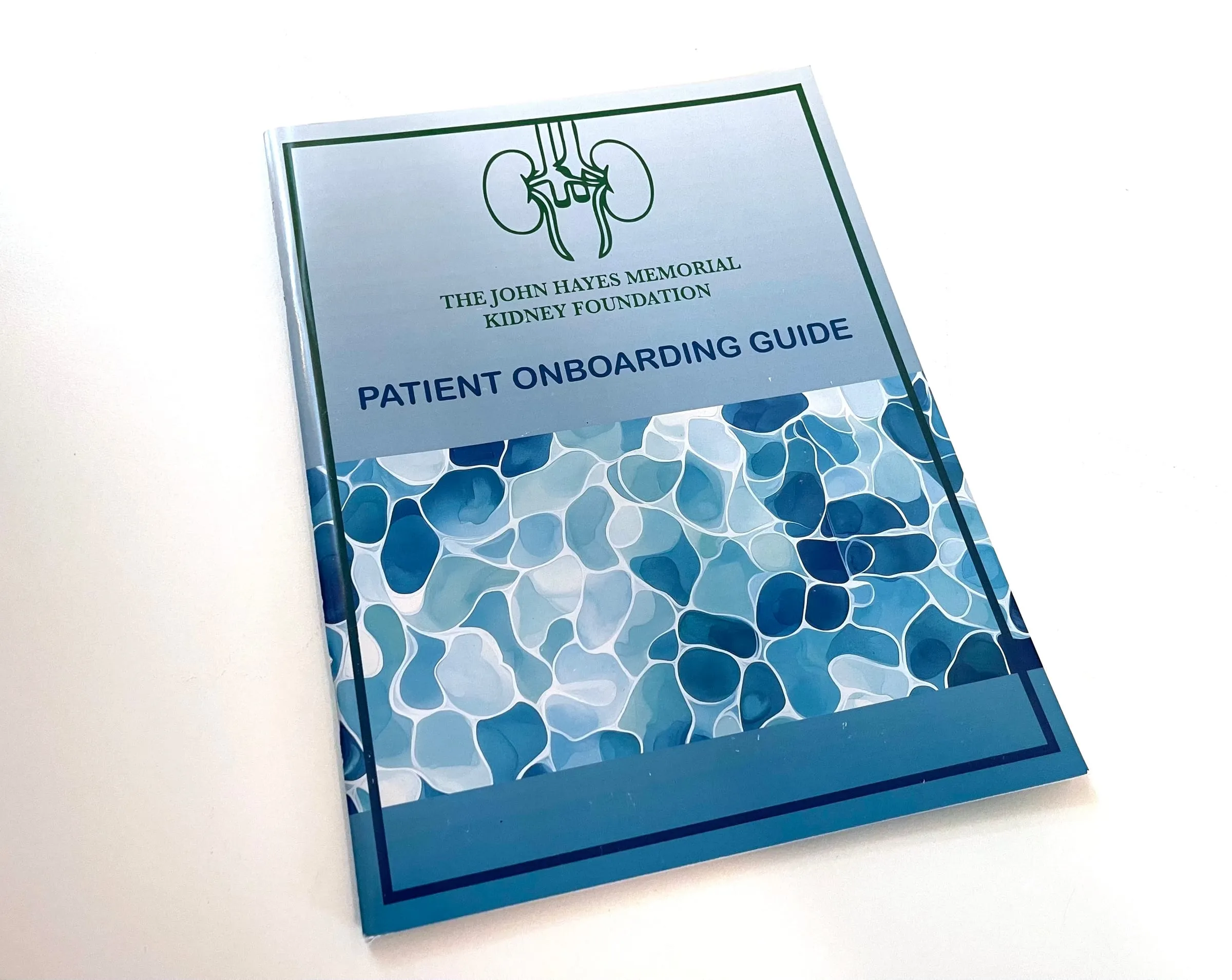 The Patient Onboarding Guide for The John Hayes Memorial Kidney Foundation, a booklet whose cover pairs a line-drawn kidney mark with a blue watercolour cell pattern.